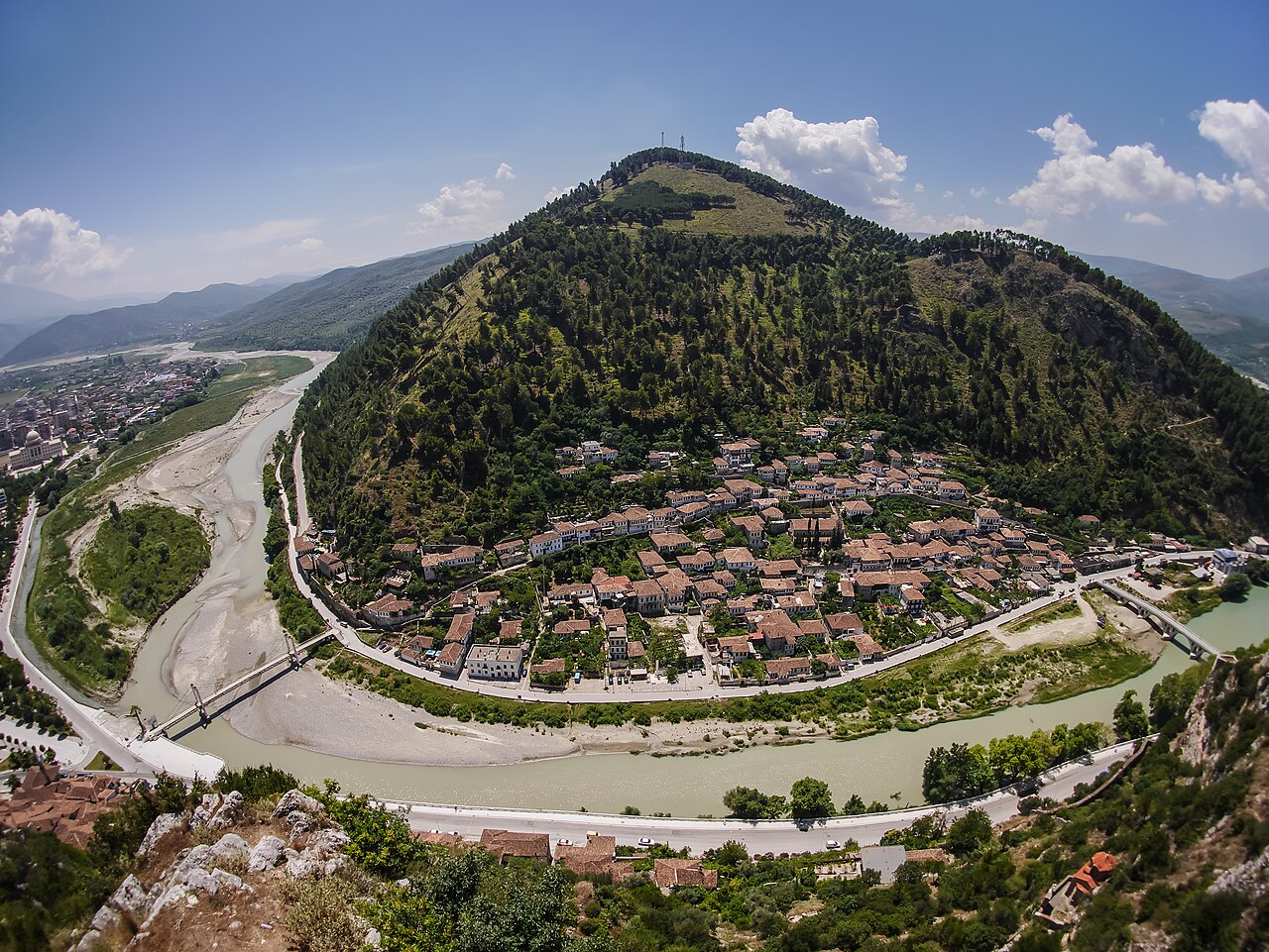 Berat's Gorica district beside the Osum River and a wooded hillside in Albania