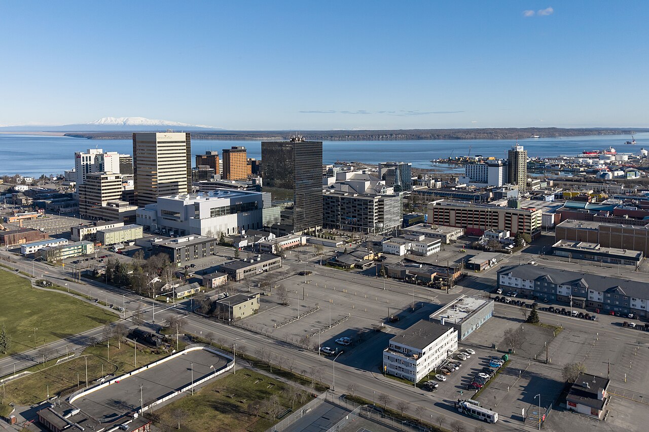 Downtown Anchorage buildings with blue water and distant mountains in Alaska