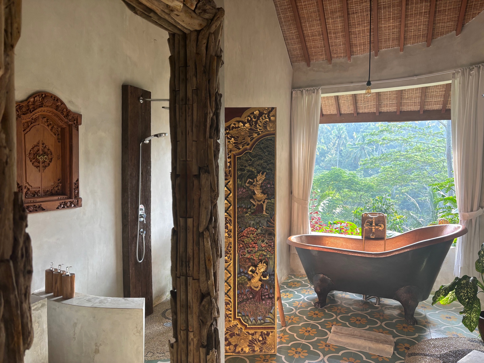 Bathroom with a freestanding copper-coloured bathtub and tropical views at Harmony Hill Bali