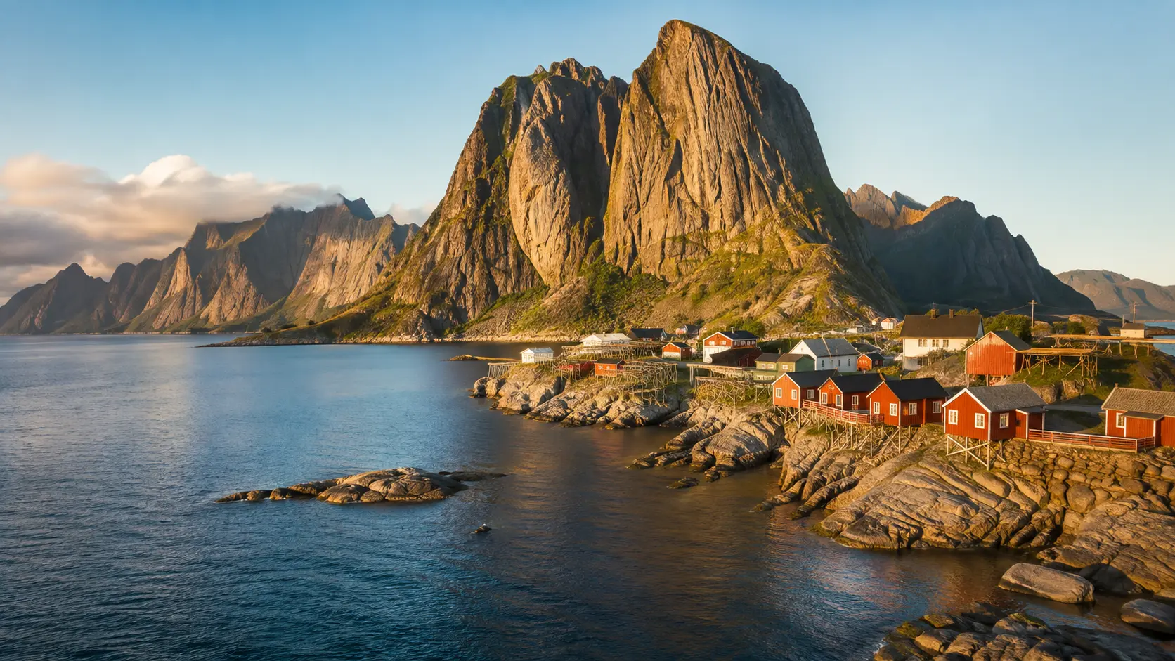 Red rorbu cabins and jagged peaks in the Lofoten Islands