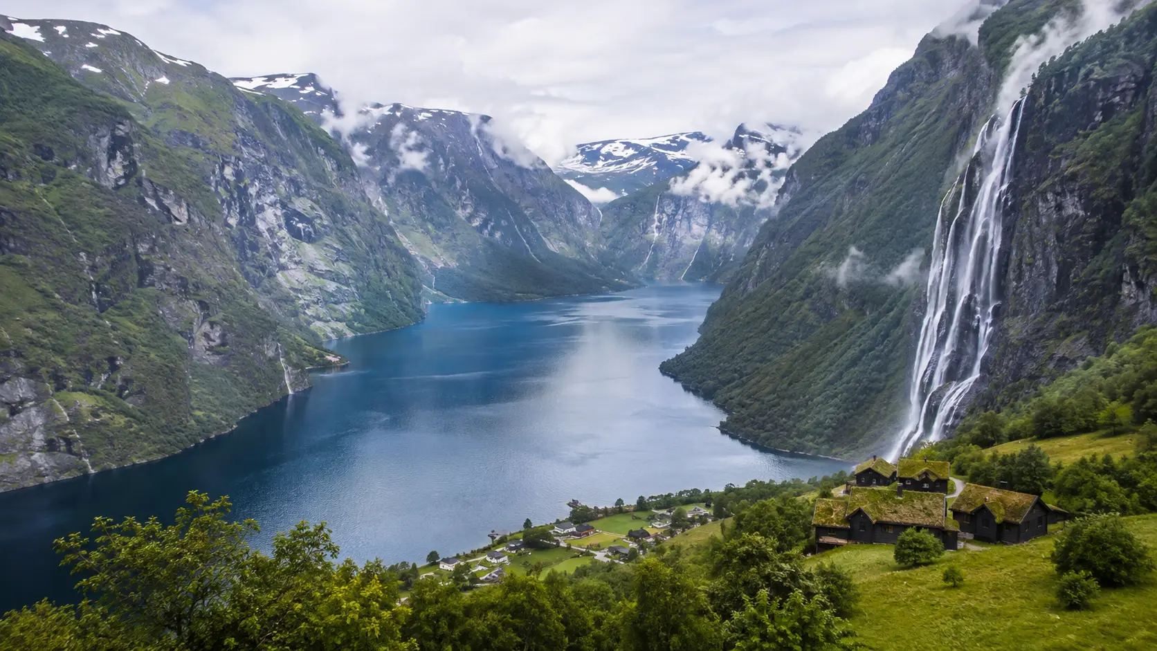 Deep Norwegian fjord with mountains and waterfalls