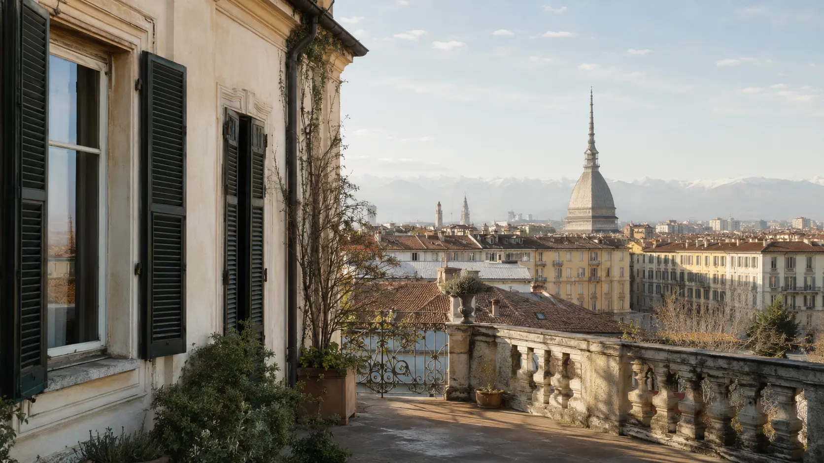 Historic Turin hotel terrace overlooking the Mole Antonelliana and the Alps